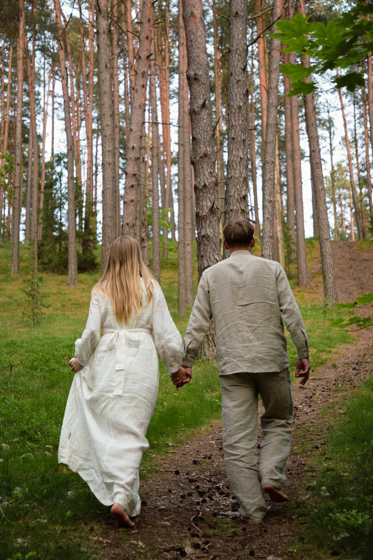 A couple walking along a forest path in Aukštaitija